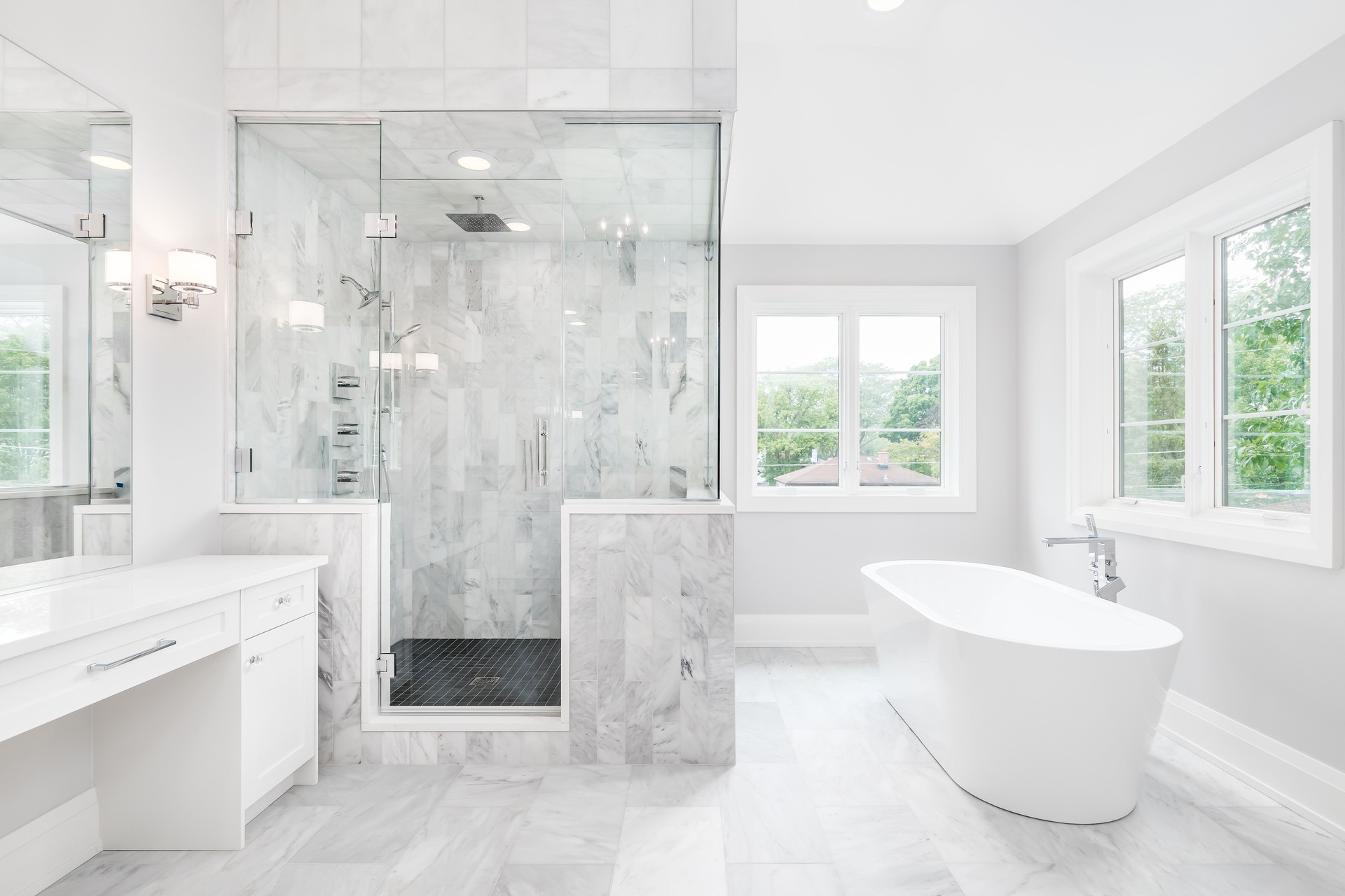 A luxury bathroom with a walk-in tiled shower and standalone tub.